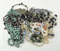 A collection of beaded necklaces of various colours,