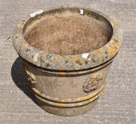 A large stone garden pot with decorative ribbing,