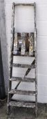 A wooden five tread step ladder