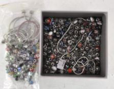 A large quantity of glass Pandora style charms, of assorted colours and designs,