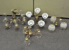 Four brass and gilt-metal chandeliers, wtih glass shades,