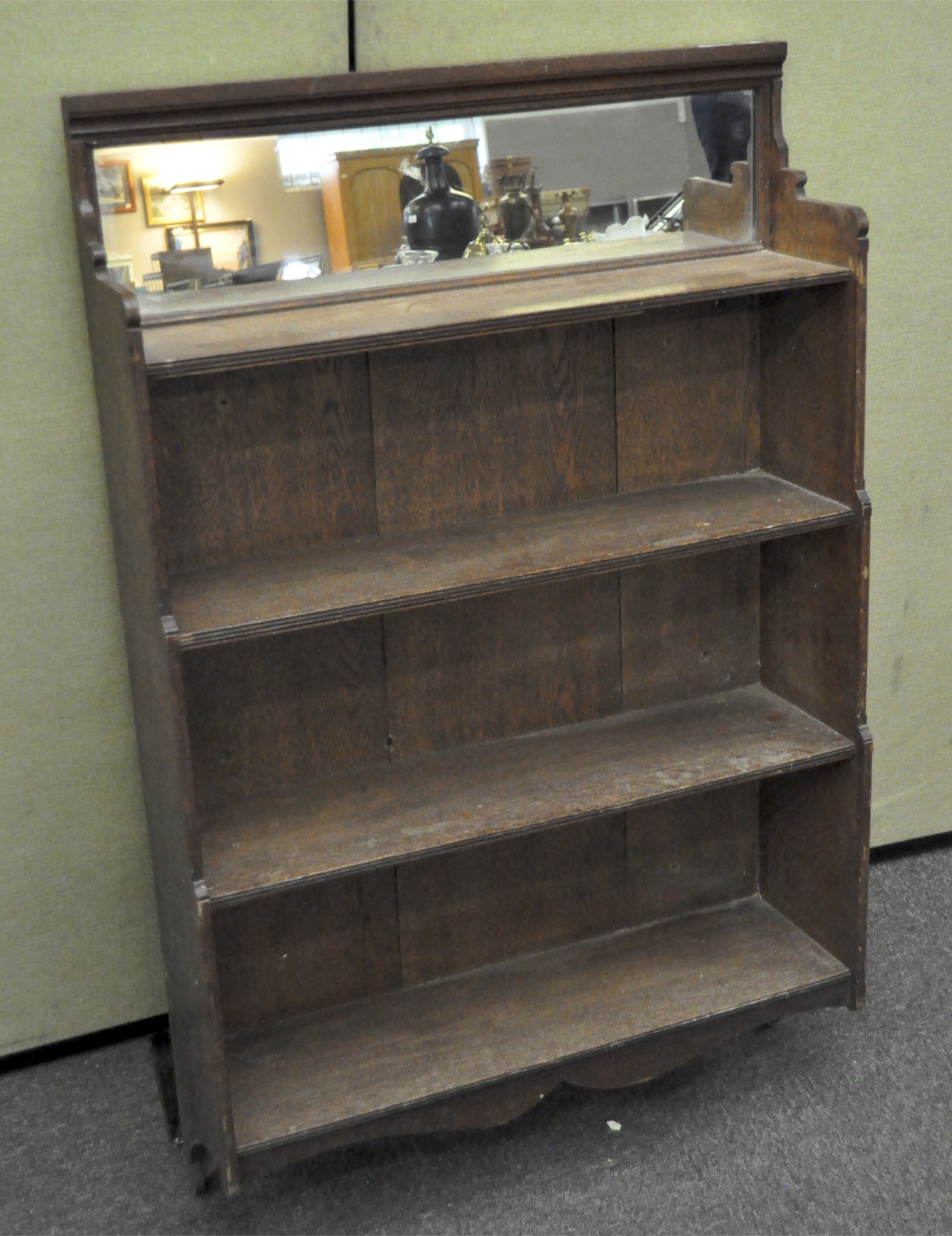 An oak three-shelf unit, perhaps part of a dresser, the upper part with mirror above three shelves,