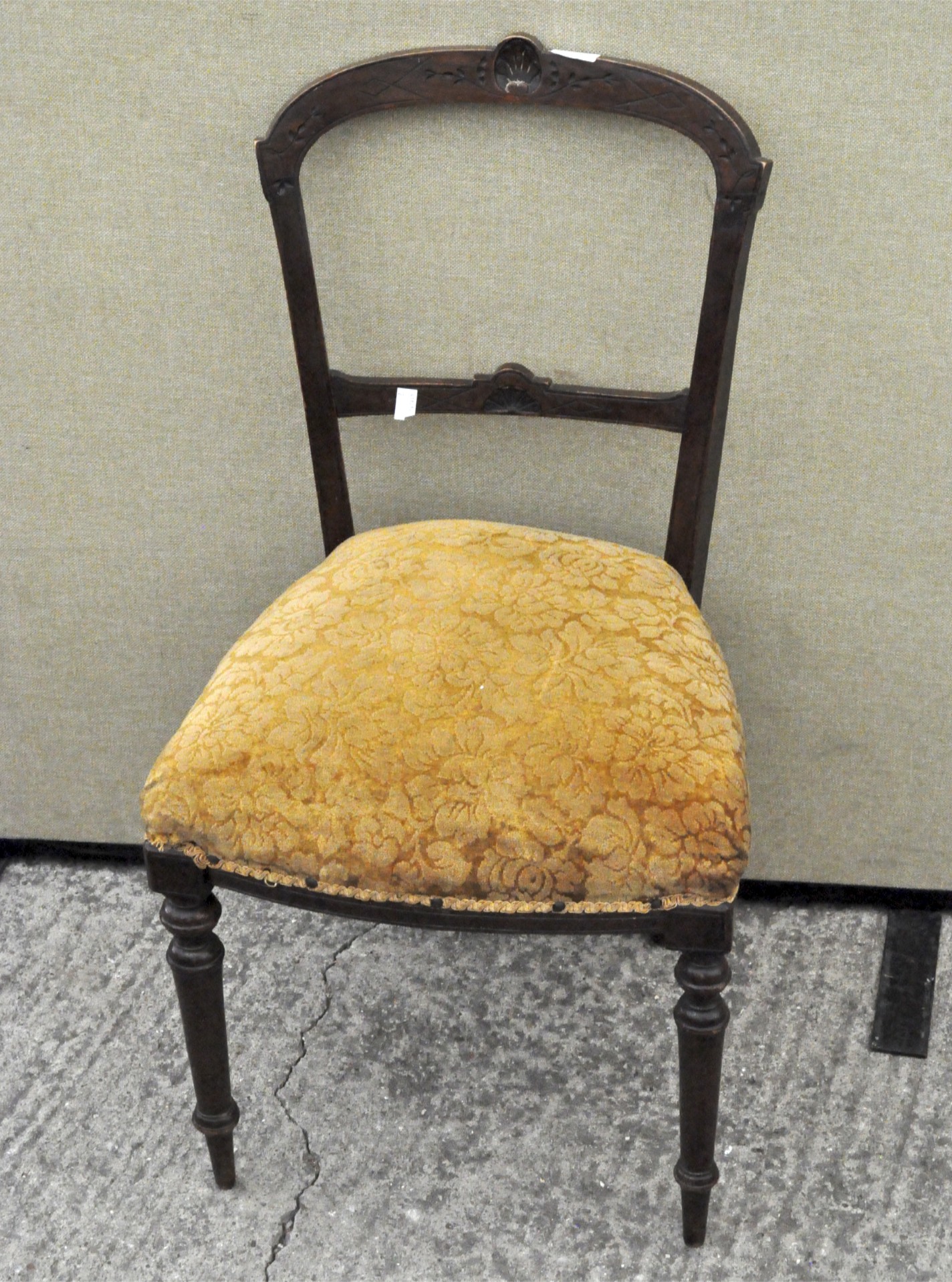 A Victorian mahogany chair with floral upholstered seat and foliate carved back,