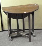An oak gate leg side table, of circular form,