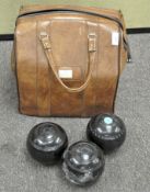 A set of three vintage Vitalite lawn bowling balls in a vintage brown bag