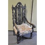 A Victorian oak carved armchair, carved with acanthus and scrolls with column uprights,