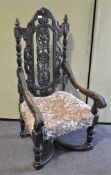 A Victorian oak carved armchair, carved with acanthus and scrolls with column uprights,