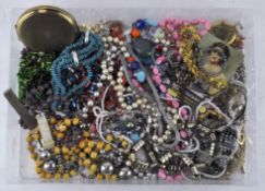 A box of costume jewellery, including a Stratton compact, pendants,