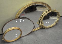 A large oval gilt mirror together with a wood framed oval mirror and two further mirrors,