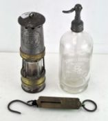 A glass soda syphon together with vintage gas lamp and a Pocket Balance weighing scales