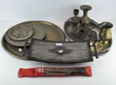A collection of assorted brassware, including three engraved chargers, two vases,
