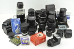 A selection of camera lenses, tele-converters, flash guns and accessories,