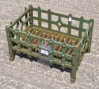 A green painted metal fire basket,