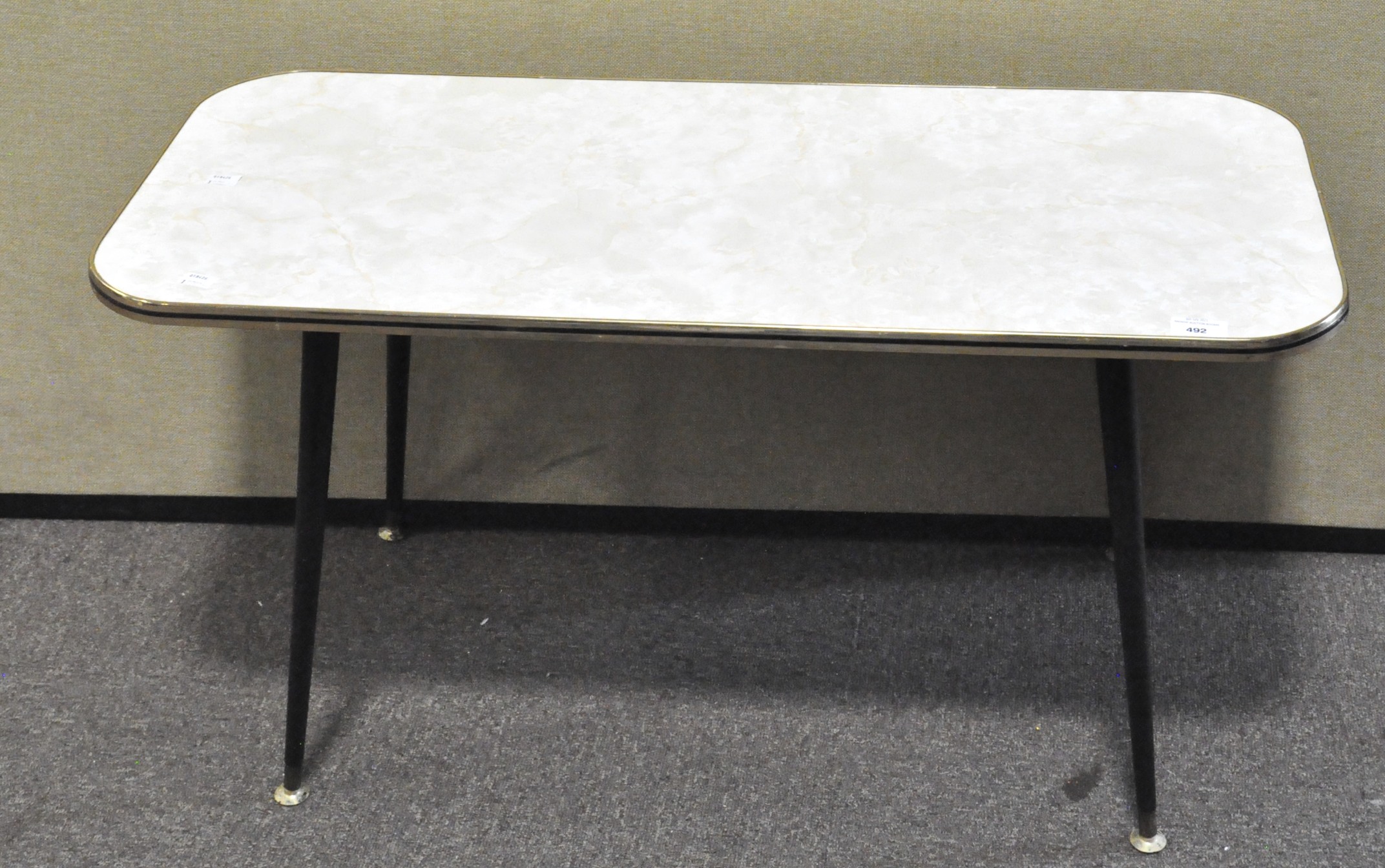 A mid century coffee table of rectangular form, rounded edges,