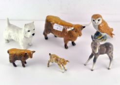 A collection of Beswick animals, including an owl, cows,