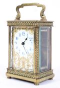 A French brass carriage time piece, 20th century, the ivorine dial with gilt metal,