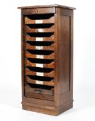 An early 20th century optician's oak tambour filing cabinet, bearing ivorine label for Cooke's,