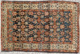 A Kashan style rug with an over all pattern of stylised flowerheads,