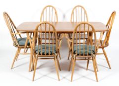 An Ercol blonde elm and beech rectangular dining table, five Quaker carver chairs and one chair,