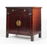 A Chinese hardwood cabinet, with two short drawers above two doors enclosing a shelf,