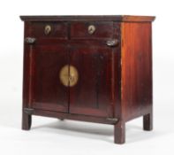 A Chinese hardwood cabinet, with two short drawers above two doors enclosing a shelf,