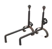 A pair of iron fire dogs, each with ball finials and pierced cross ornament to adjustable support,
