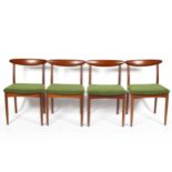 Four mid century Greaves and Thomas teak chairs, tapering back rests, with green upholstered seats,