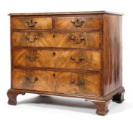 A George III walnut chest of two short and three graduated long drawers with cockbeading