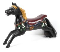 Woody White, a carved galloping carousel horse in walnut in smaller size,