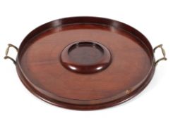 A 19th century mahogany circular tray, with central stand and two brass handles,