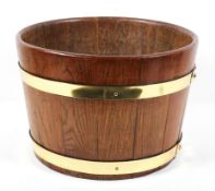 An oak brass mounted cylindrical bucket, with copper studs, late 19th/early 20th century,