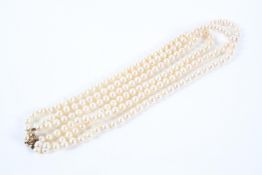 A three row cultured pearl necklace.