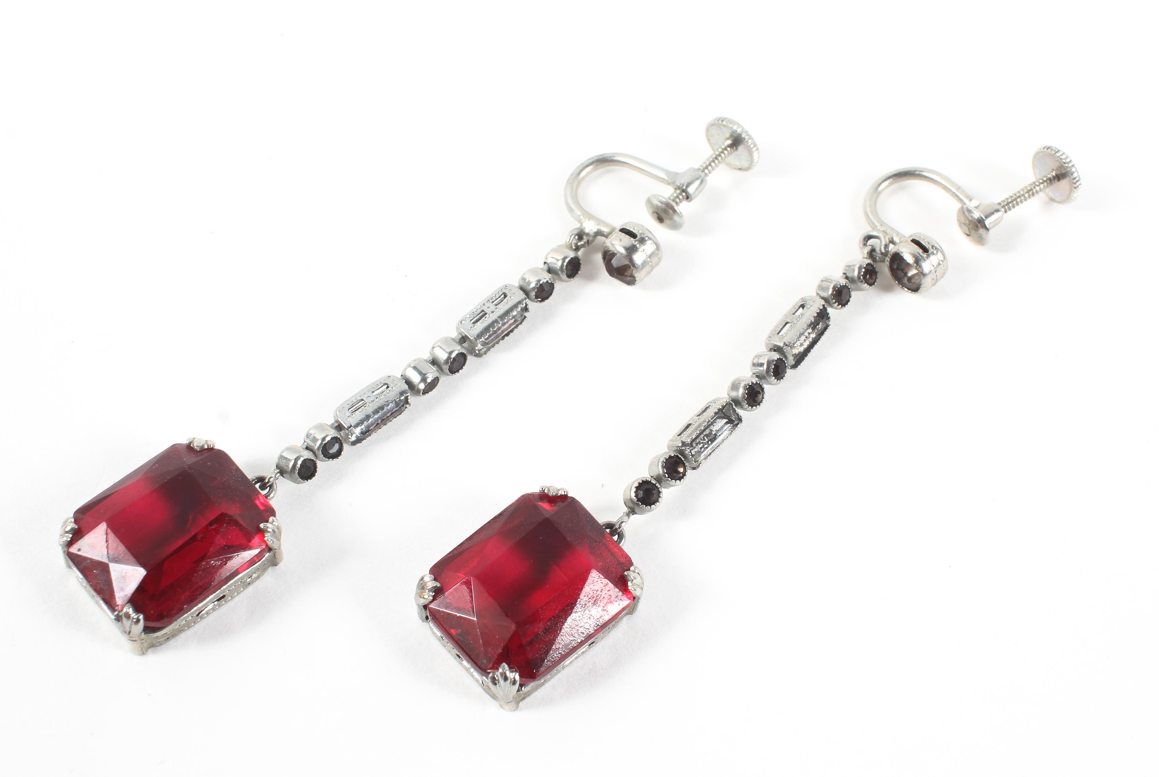 A pair of drop earrings.