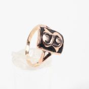 A rose metal signet ring having black enamelled finish embossed with initial 'S' No hallmark;