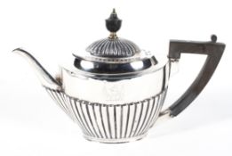 A Mappin and Webb silver teapot, of oval form with stop fluted decoration,