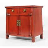 An Chinese red painted hardwood cabinet, with two drawers above two cupboard doors,