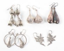 A collection of five pairs of earrings of various designs. Some are marked for sterling silver 925.