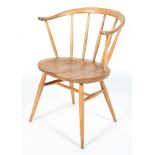 An Ercol blonde elm and beech Windsor style armchair, with wishbone shaped back, on splayed legs,