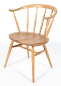 An Ercol blonde elm and beech Windsor style armchair, with wishbone shaped back, on splayed legs,