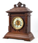 A mahogany cased mantel clock, late 19th century, with a 4 1/2" ivorine dial,