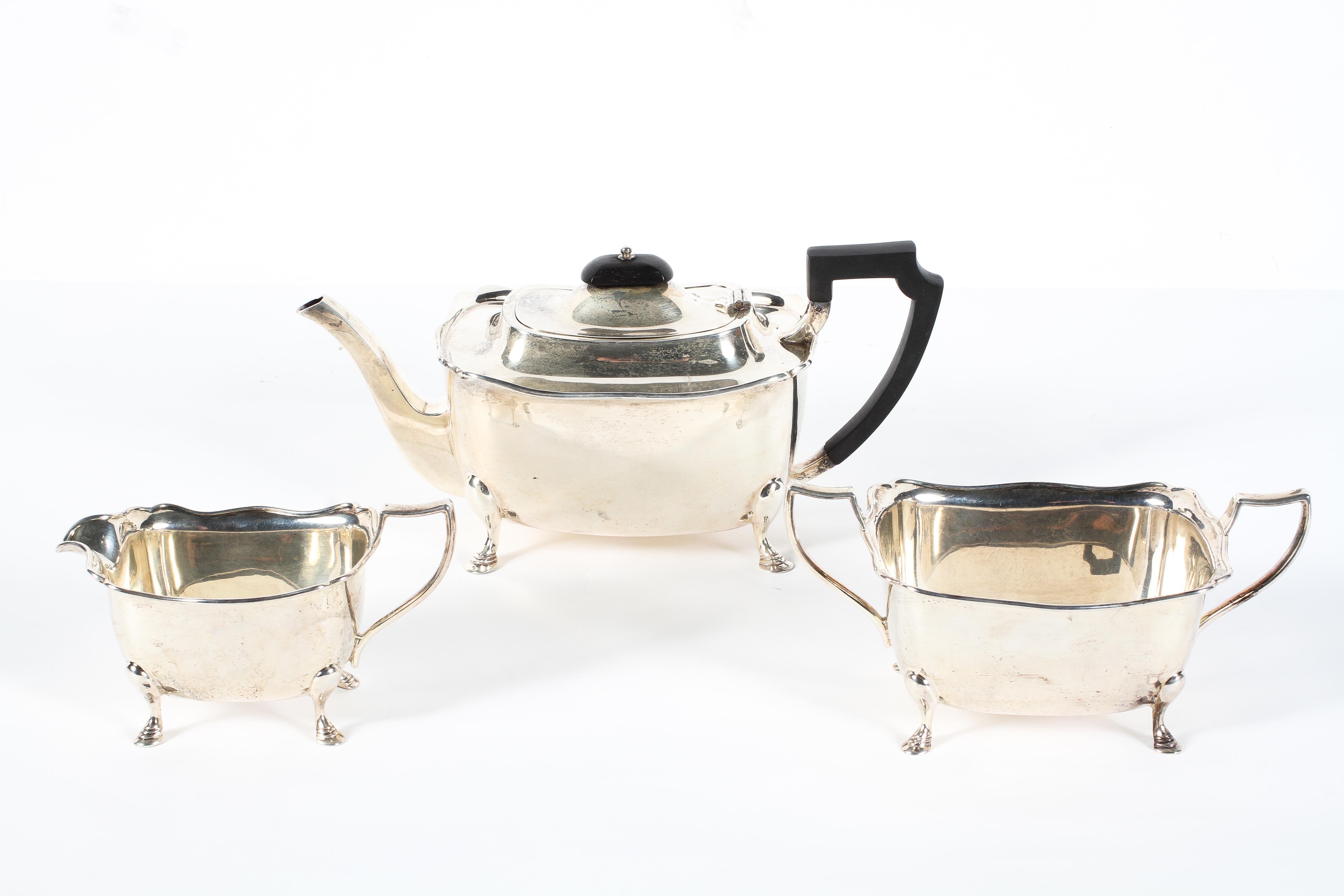 A George V three piece silver tea set, comprising teapot, twin handled sugar bowl and milk jug,
