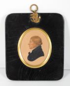 A 19th century portrait miniature of a man in profile,