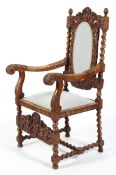 A Victorian carved walnut arm chair,