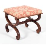 A Victorian style mahogany X frame stool, the rectangular top on a foliate carved frame,