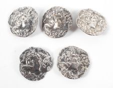 A set of five Art Nouveau silver buttons, each adorned with a female,