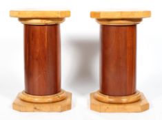 A pair of Biedermeier style pedestals, 20th century, veneered in cherry and pale wood,