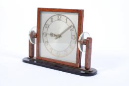 A Continental Art Deco square section 8 day desk clock, the metal frame in simulated tortoiseshell,