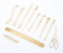 A collection of carved bone items, late 19th/early 20th century, comprising: scissors, spoons,