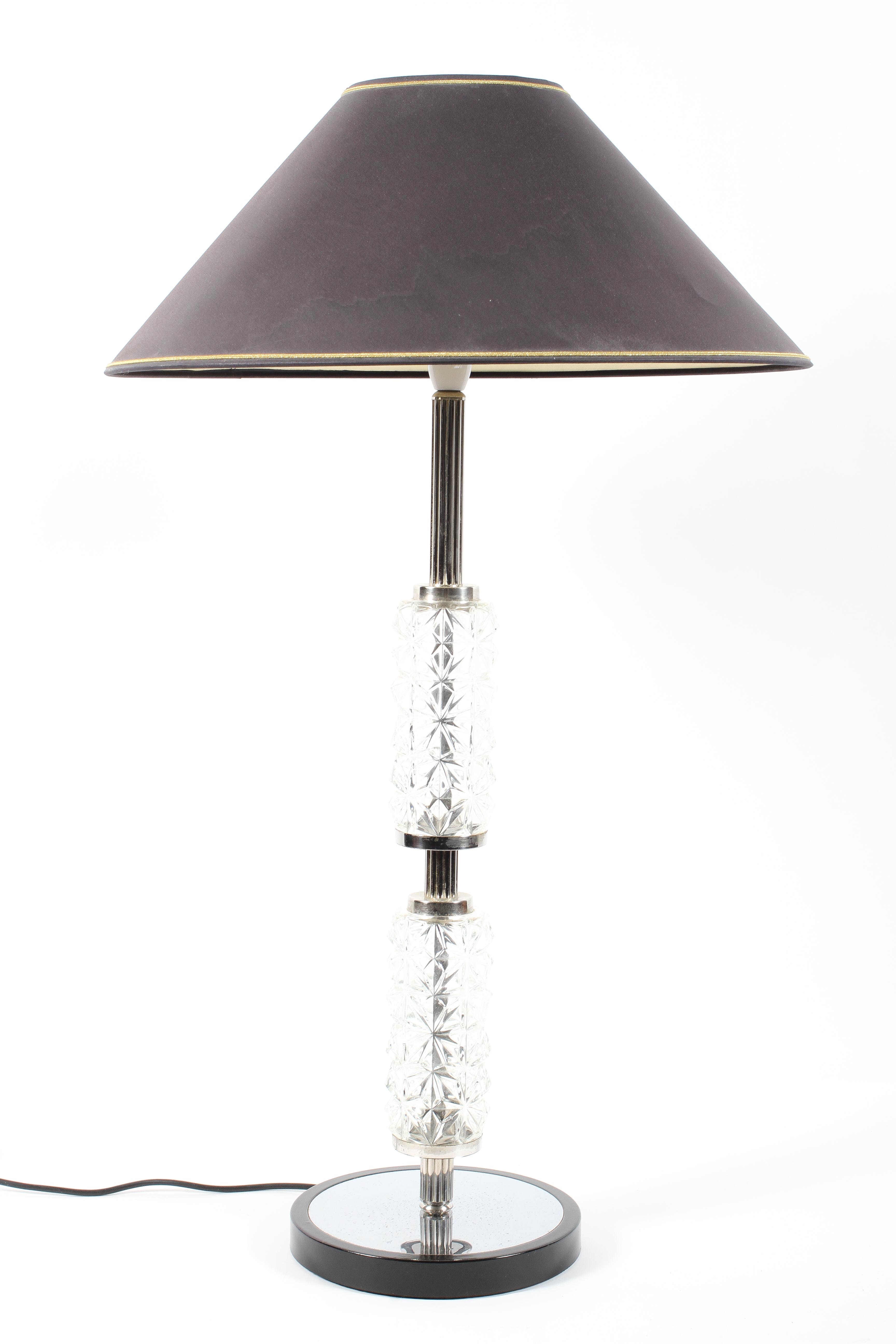 A mid century style glass and chrome table lamp with black shade, circa 1960,