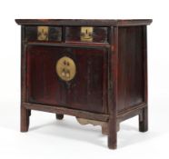 A Chinese hardwood cabinet, with two drawers above two cupboard doors, enclosing a shelf,